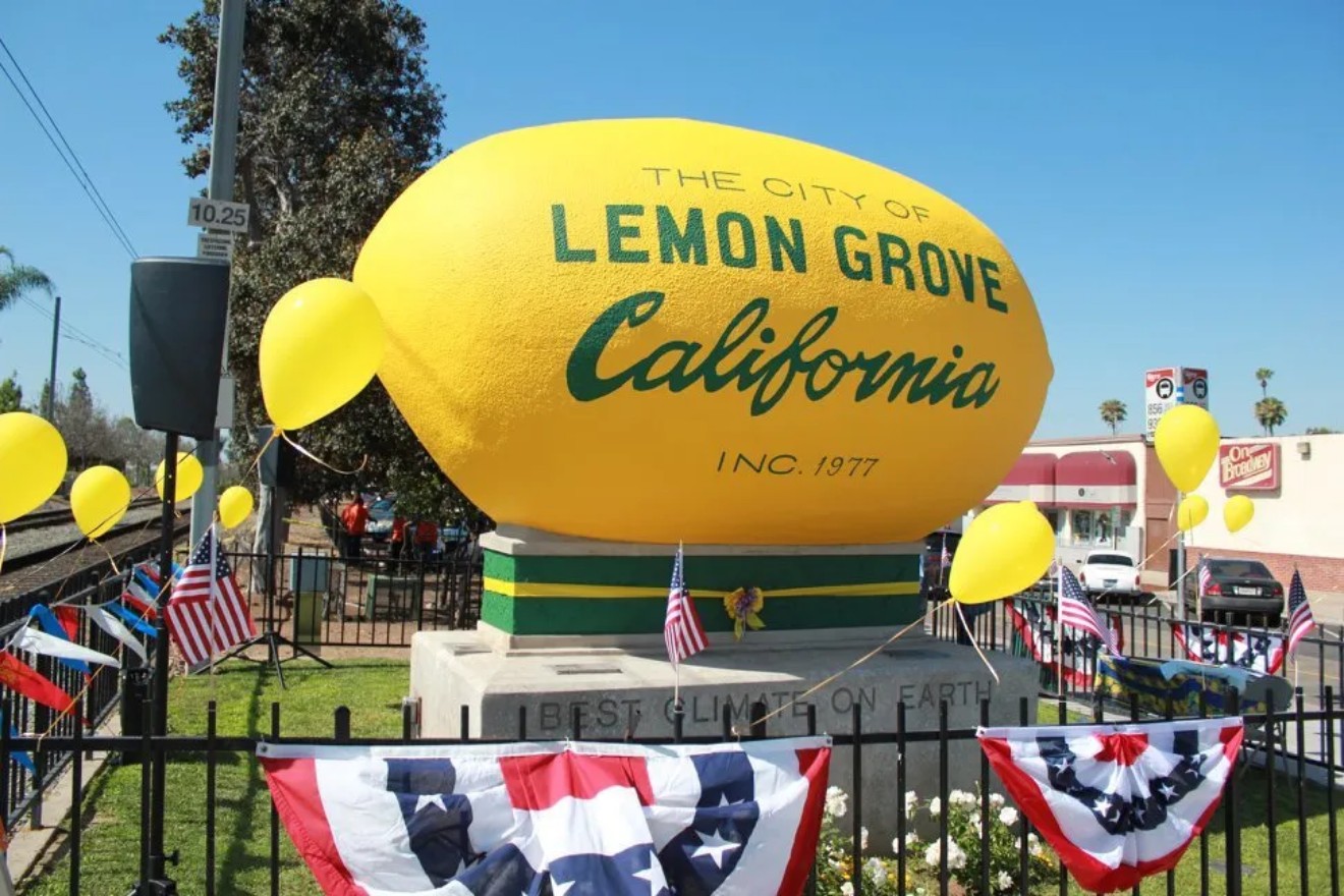 The Lemon Grove Big Lemon monument decorated with balloons and American flag bunting for a community celebration